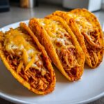 Four crispy, crunchy chicken tacos filled with shredded chicken and topped with melted cheddar and Monterey Jack cheese.