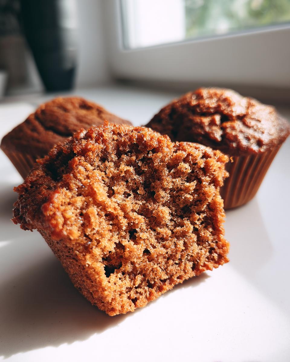 Close-up showing the moist, crumbly texture inside one of the homemade bran muffins.