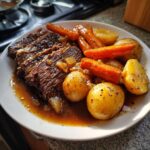 Slices of tender pot roast served with roasted potatoes and carrots, perfect for Sunday dinner ideas.