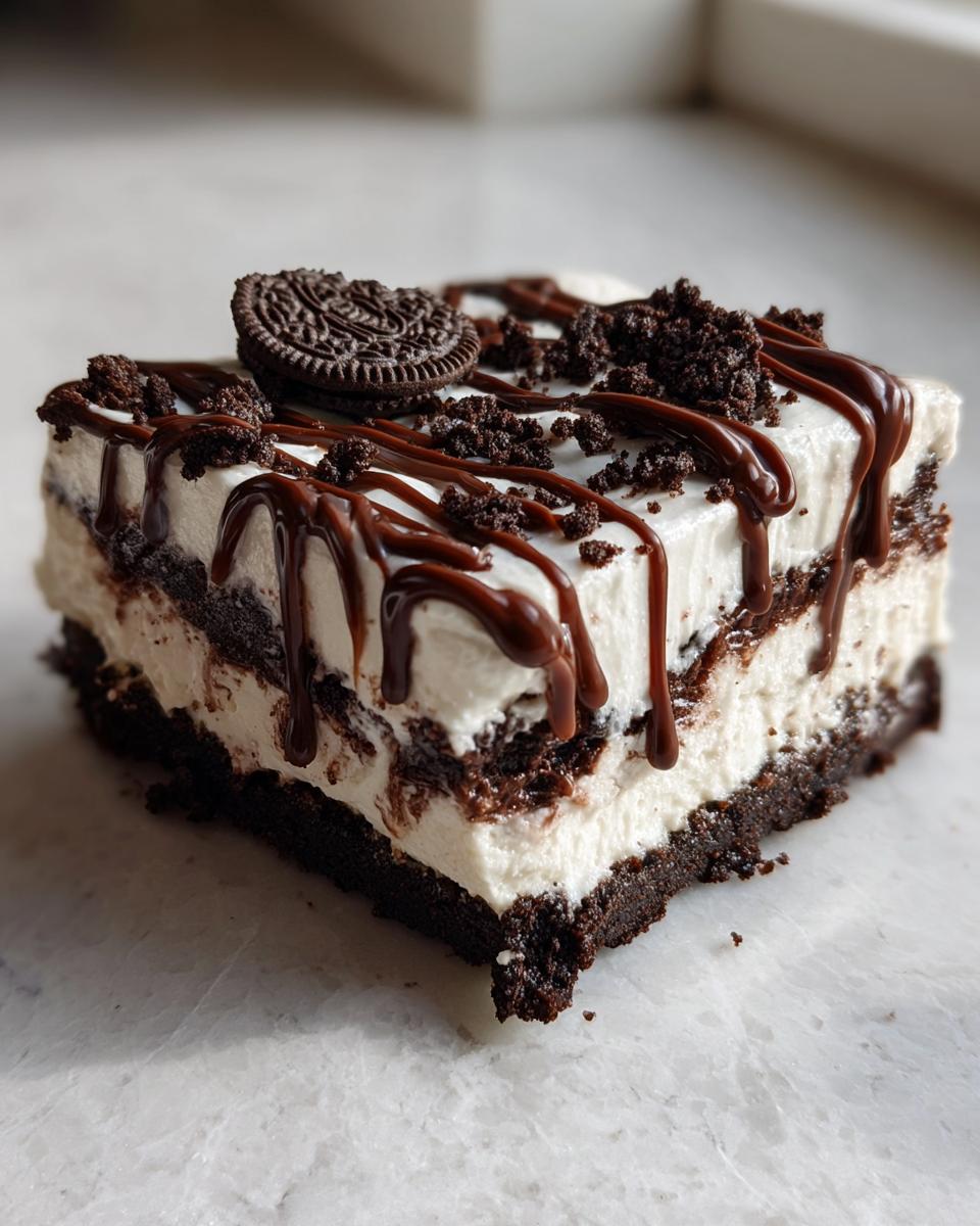 A rich slice of Baileys Chocolate Cheesecake Trifle layered with cream and chocolate drizzle.