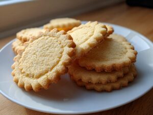 Close-up of a stack of perfectly shaped, scalloped-edge sugar cookie dough that held its shape after baking.