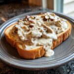 A thick slice of toasted bread generously covered with creamy chipped beef on toast gravy.