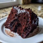 A moist, dark chocolate slice of capricorn cake covered in glossy ganache.