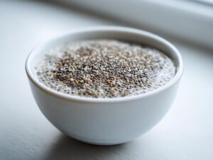 Close-up of a white bowl filled with freshly made chia seed pudding, showing the hydrated seeds.