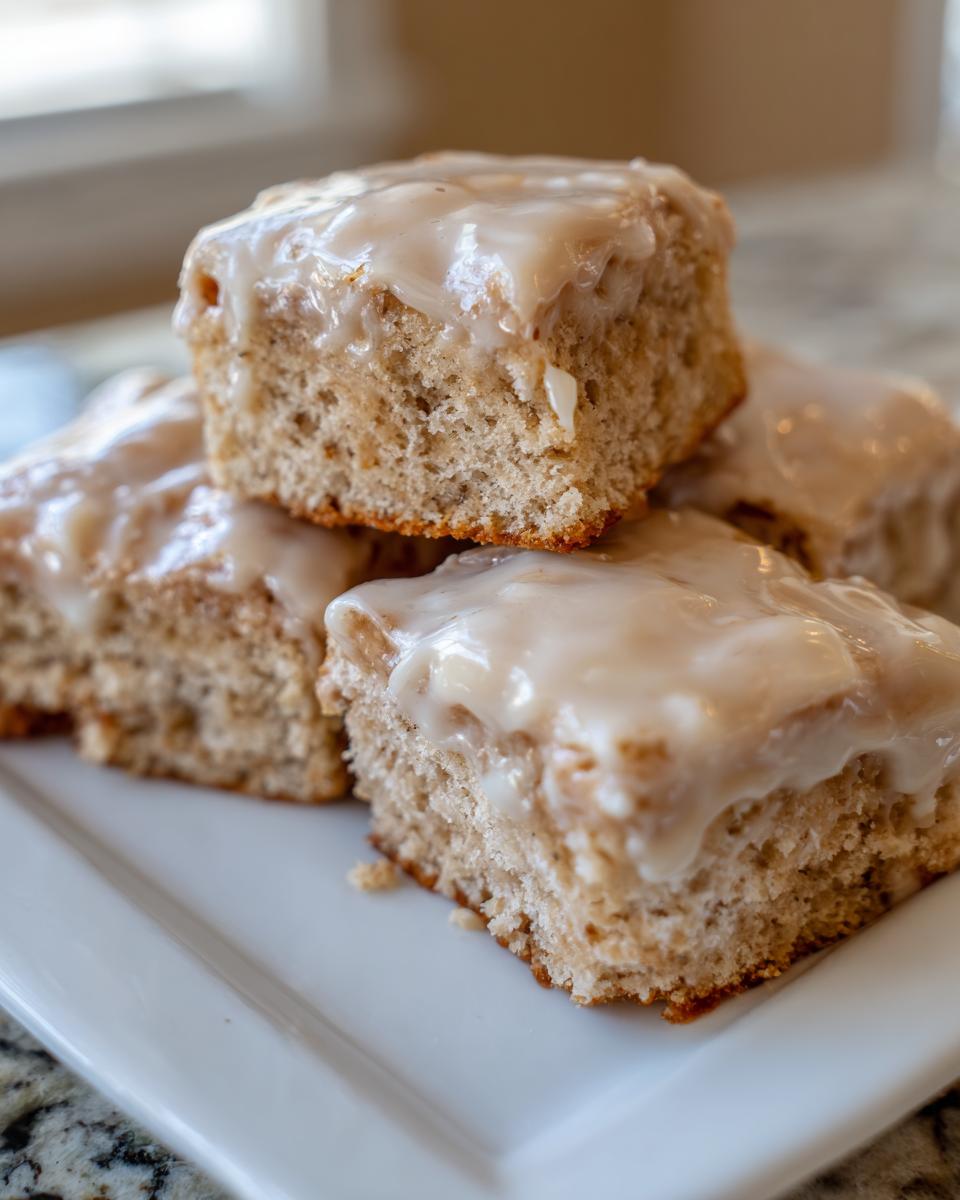 Close-up of stacked maple donut bars topped with a thick, glossy maple glaze.